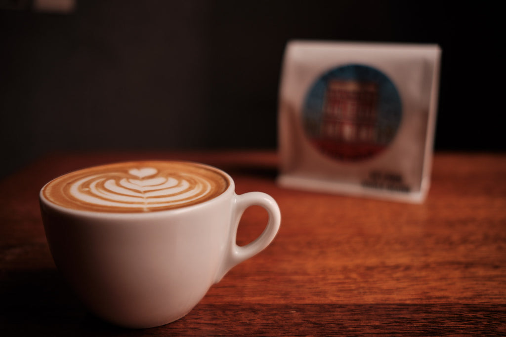 Flat white with a bag of La Veen Heritage coffee