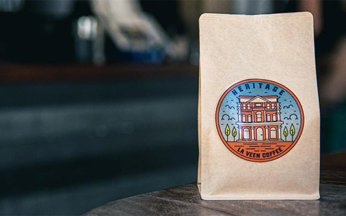 La Veen Heritage whole bean coffee bag on a café counter